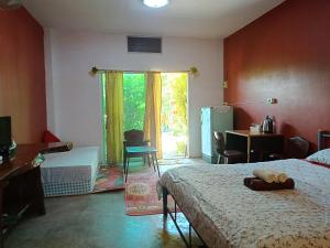 a bedroom with a bed and a desk and a window at Six Nature Resort in Chiang Rai +79 photos