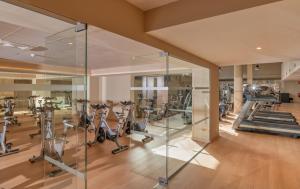 a gym with treadmills and exercise bikes in a room at AQUA Hotel Onabrava & Spa 4*Sup in Santa Susanna