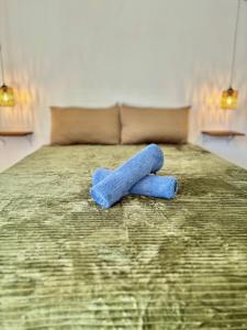 a blue teddy bear sitting on top of a bed at Araw Boutique in General Luna