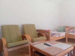 a room with three chairs and a table and a couch at Apartman Sobek in Bajina Bašta +40 photos