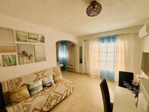 a living room with a couch and a window at Apartamento Amy 4 in Huelva