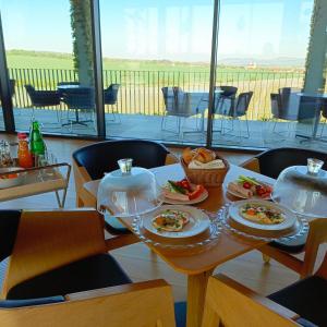 a table with plates of food on top at Vinařství Obelisk in Valtice