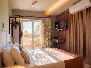 a hotel room with a bed and a balcony at The Mdina Heritage Boutique Hotel - By Luxury Villas International in Rabat