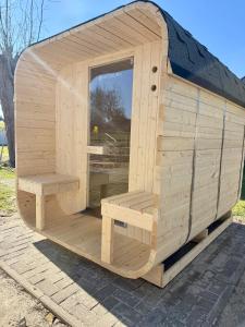 a wooden sauna with two benches in it at Familienbett und Sauna - Muschelbude in Wittenbeck