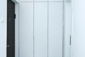a row of white cabinets in a room at Studio Mare Kotor in Dobrota