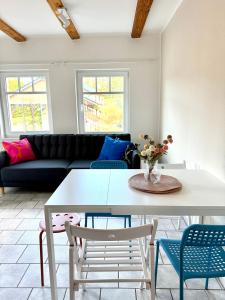 a living room with a white table and chairs at Familienbett und Sauna - Muschelbude in Wittenbeck