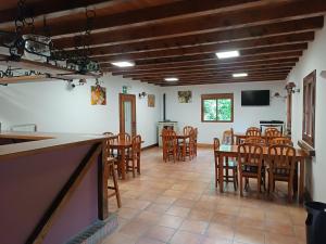 a dining room with wooden chairs and a table at Albergue Casa Txakainlo in Lesaka