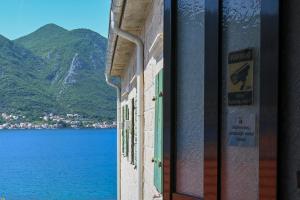a view of a lake from a window of a building at Studio Mare Kotor in Dobrota