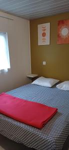 a bedroom with a bed with a red blanket on it at Camping la Source in Sournia +91 photos