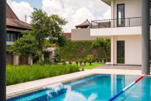 an external view of a villa with a swimming pool at Villa 234 Yogyakarta in Yogyakarta