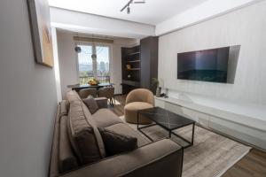 a living room with a couch and a table at Hotel Cube 55 - Business Suites in Skopje