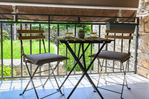 a table and two chairs on a balcony at Studio Mare Kotor in Dobrota