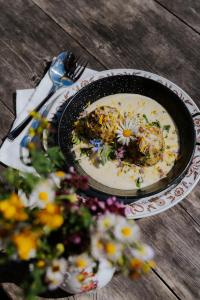 a plate of food on a table with flowers on it at Branntweineralm in Tamsweg