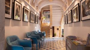 a row of blue chairs in a waiting room at The Mdina Heritage Boutique Hotel - By Luxury Villas International in Rabat
