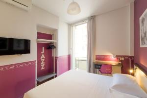 a hotel room with a bed and a desk at Sure Hotel by Best Western Nologo in Genoa