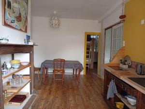 a kitchen with a table and a dining room at Air de Monade in Oloron-Sainte-Marie +2 photos