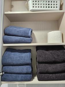a closet with towels and a basket and towels at Hongdae ssuny house in Seoul +65 photos