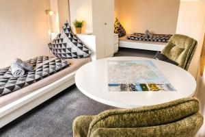 a room with a table and chairs and a bed at Ferienhaus Klaus in Berumbur