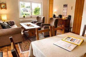 a living room with a table and chairs at Ferienhaus Klaus in Berumbur