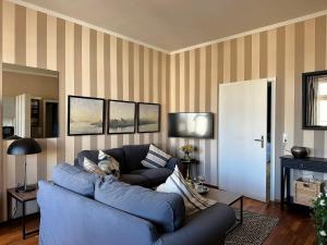 a living room with a blue couch and a fireplace at Ferienwohnung Boppard in Boppard