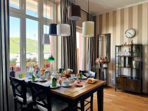 a dining room with a table with chairs and a clock at Ferienwohnung Boppard in Boppard