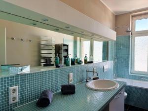a bathroom with a sink and a mirror at Ferienwohnung Boppard in Boppard +32 photos
