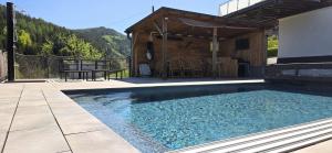 a swimming pool in front of a house at Landhaus Pool and Relax in Bruck an der Mur