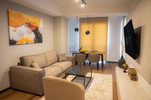 a living room with a couch and a table at Hotel Cube 55 - Business Suites in Skopje