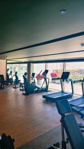 a gym with a bunch of treadmills and machines at Apartment at Vida Marina Marassi, North Coast in El Alamein