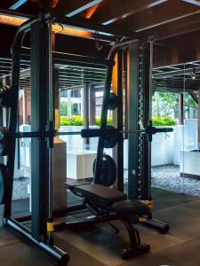 a gym with a tread machine in a building at 137 Pillars House in Chiang Mai
