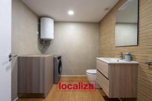a bathroom with a sink and a toilet and a mirror at Amplio y moderno apartamento in Almería +5 photos
