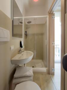 a bathroom with a toilet and a sink and a shower at Sure Hotel by Best Western Nologo in Genoa +41 photos