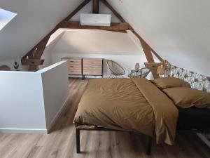 a bedroom with a bed in a attic at Gîtes La Grenouillère in Veuzain-sur-Loire +50 photos