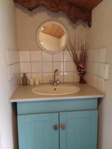 a bathroom with a sink and a mirror at Le Logis de bouillé in Bouillé-Courdault +28 photos