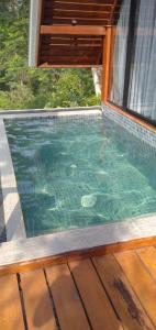 a swimming pool in a house with a window at 8 Acres Tea Escape in Deniyaya