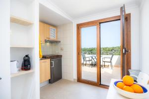 a kitchen with a door leading to a balcony at Cala Figuera Studio 5b in Cala Figuera