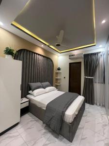 a bedroom with a large bed in a room at Travellers Heaven in Karachi +9 photos