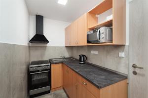 a small kitchen with a stove and a microwave at Ubytování AMZ in Vrábí +4 photos