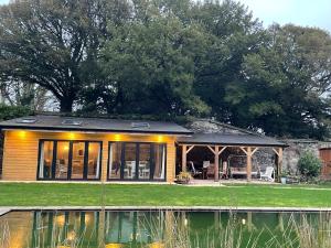 a house with a pond in front of it at Garden House Barmeath Castle in Grangebellew