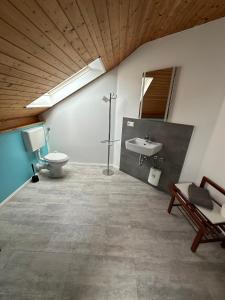 a bathroom with a toilet and a sink at Restaurant Fewo Golsong in Thaleischweiler-Fröschen +75 photos