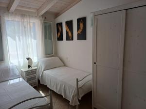 a bedroom with two beds and a window at Sole e Sale in Sardegna in Pula