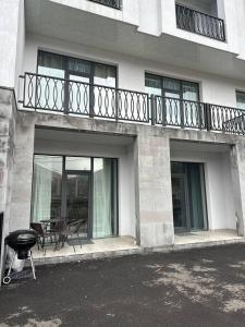 a building with a balcony with a table and chairs at Alvina Private Yard Apartment in Tsaghkadzor