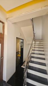 a staircase in a building with black and white stripes at Vardhan Lodge in Ajra