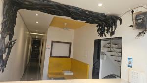 a room with a tree branch on the wall at Vardhan Lodge in Ajra +25 photos
