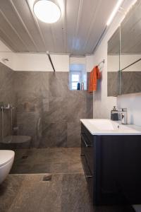 a bathroom with a sink and a toilet and a shower at Niokratis in Áno Petálion +23 photos