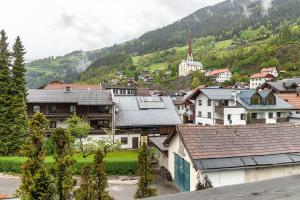 a group of houses in a town with a mountain at Appartement Azalea Oetz in Oetz