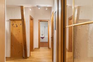 a hallway leading to a bathroom with a sink at Appartement Azalea Oetz in Oetz +19 photos