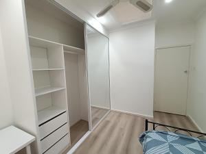a bedroom with a bed and a closet at Comfortable Queen Room - Merrylands - NM4 in Merrylands