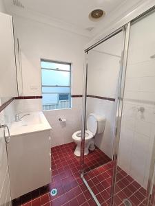 a bathroom with a toilet and a sink and a shower at Comfortable Queen Room - Merrylands - NM4 in Merrylands