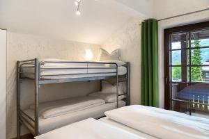 a bunk bed room with two bunk beds and a window at Appartement Azalea Oetz in Oetz